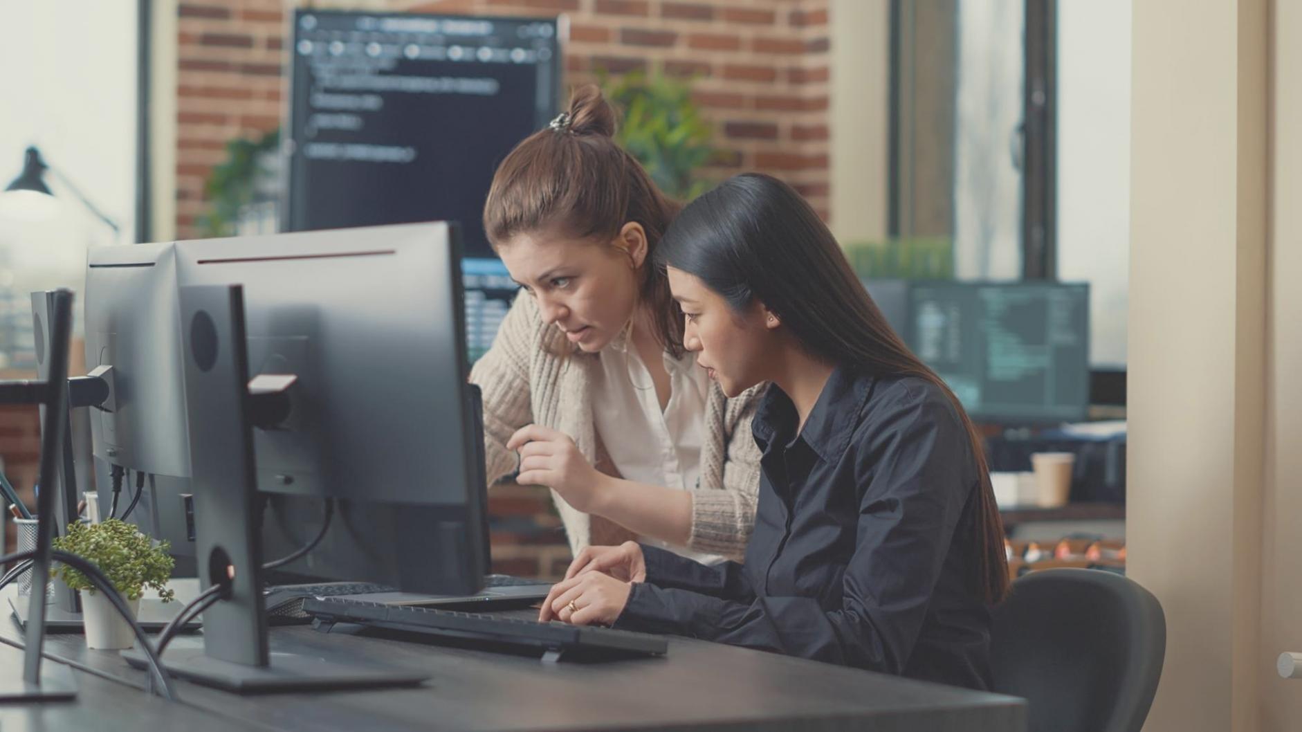 Professional demonstrating software integration on multiple screens